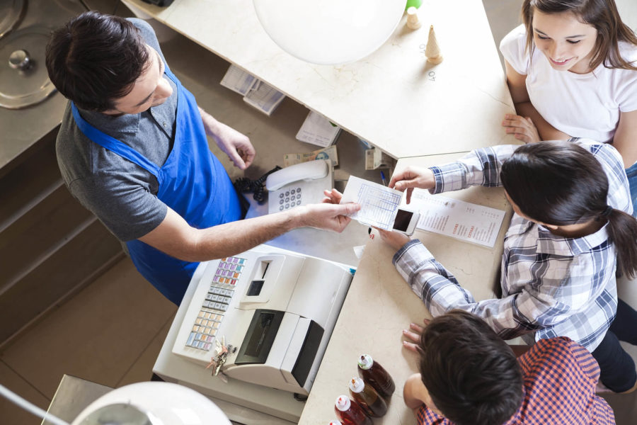 waiter giving receipt to the woman