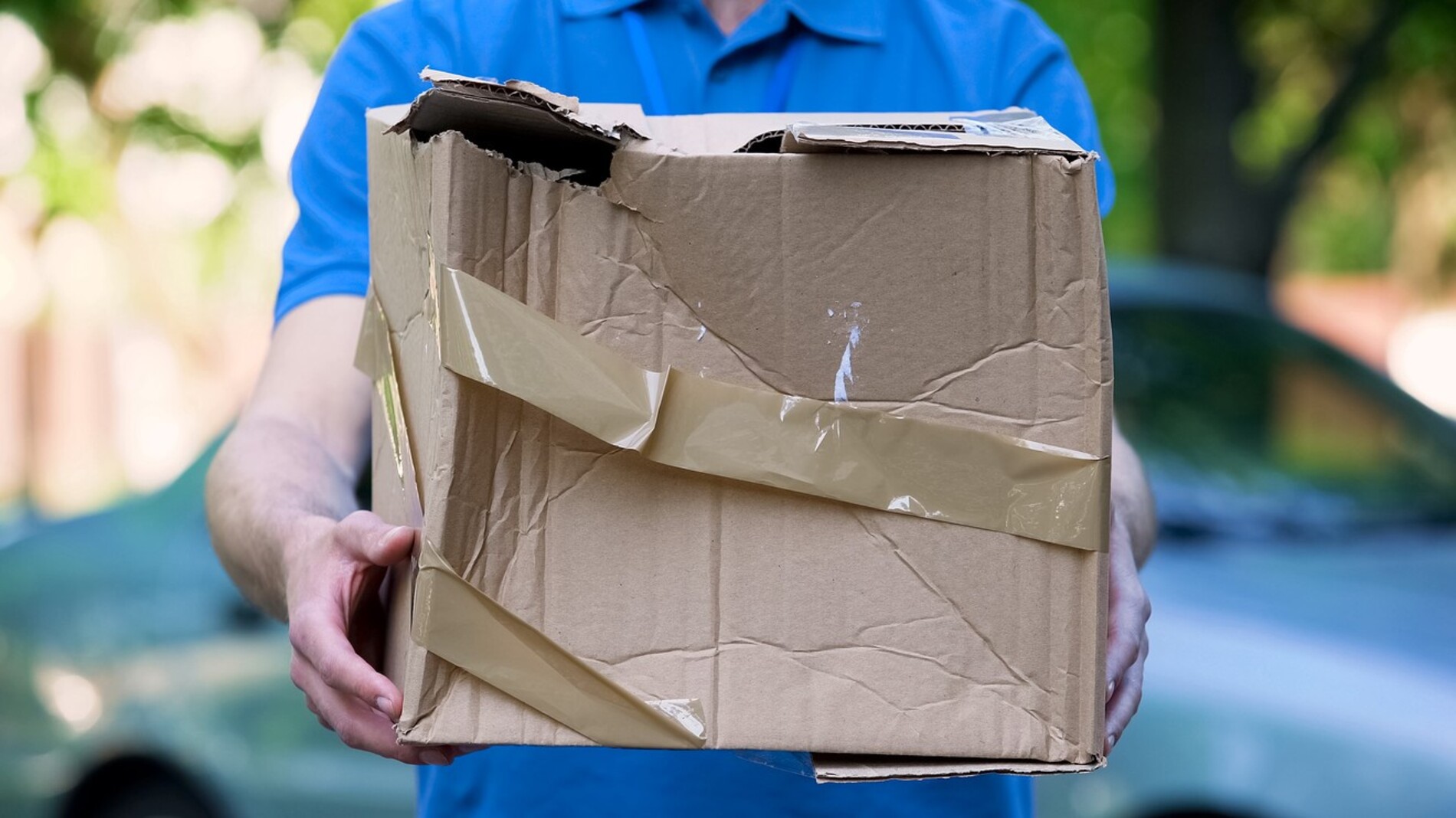 A-delivery-man-holding-out-damaged-package